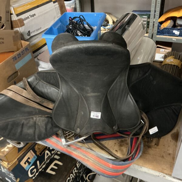 Vintage leather horse saddle, showing signs of wear and use.