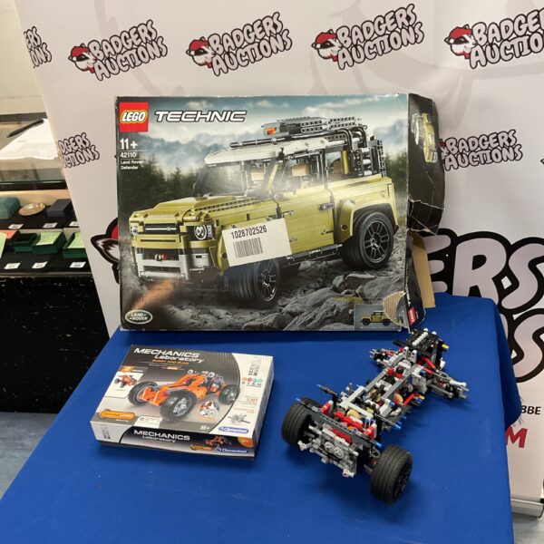 Partially built Lego Technic Land Rover Defender model 42110 with other Lego sets.