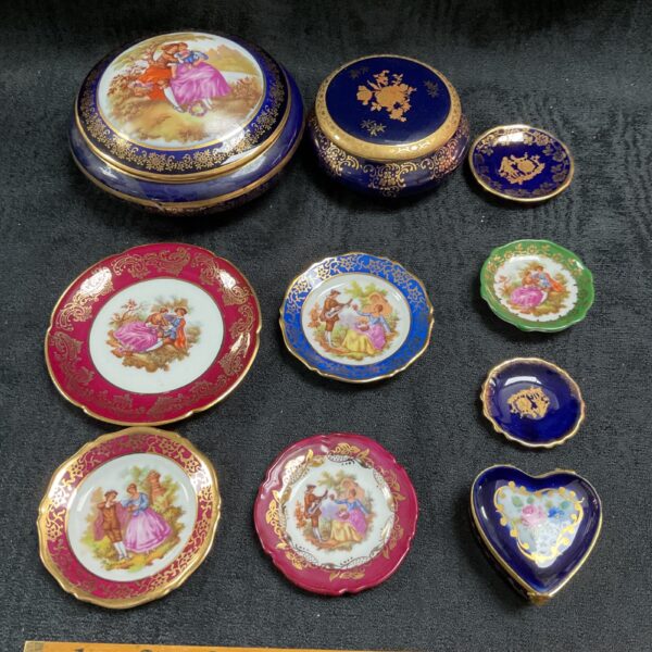 Antique Limoges porcelain box with a hand-painted romantic scene.