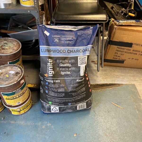 Bag of lump wood charcoal for outdoor grilling and barbecues.