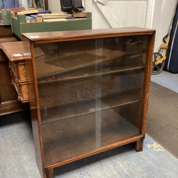 Small antique mahogany glass front bookcase for display.