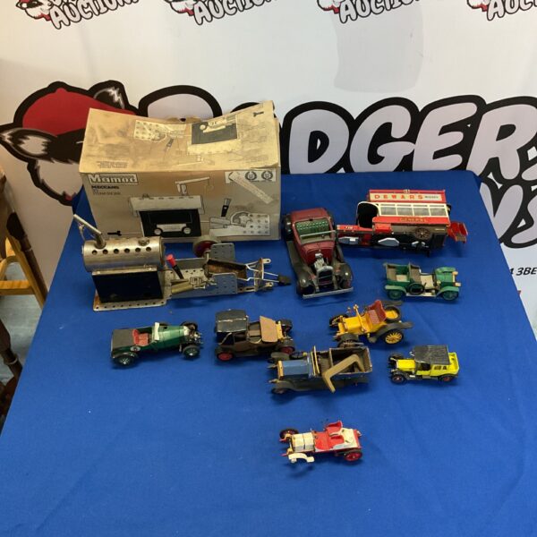Vintage Mamod steam engine with miniature model cars on display.