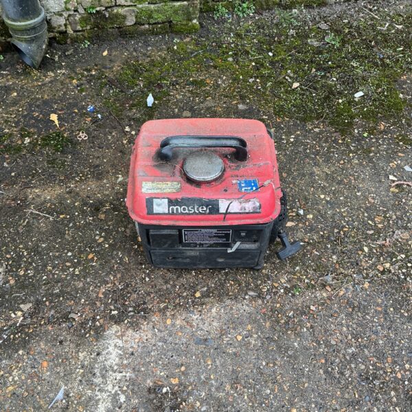 Side view of a used Master petrol generator for outdoor power.