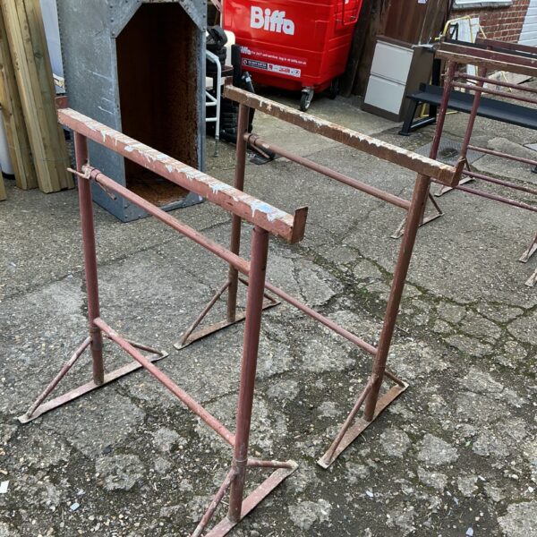 Set of used metal builders trestles for workshop or construction.