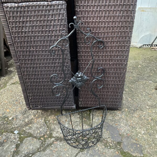 Vintage metal plant basket for wall hanging, decorative garden planter.