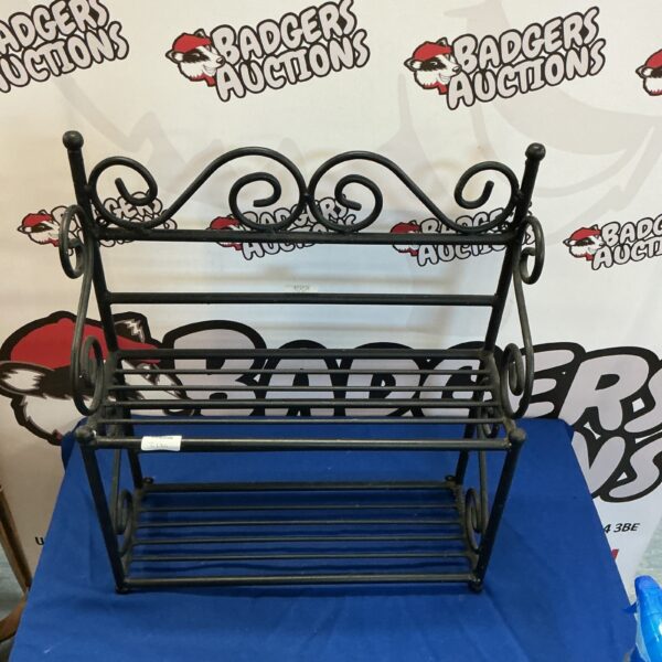 Vintage three-tier metal storage rack for display or storage.