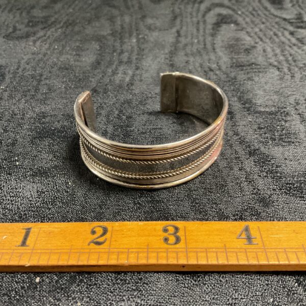 Silver tone mid-century cuff bracelet with rope twist detail.