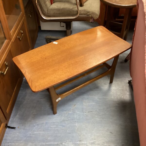 Warm toned mid-century Scandinavian coffee table with tapered legs.