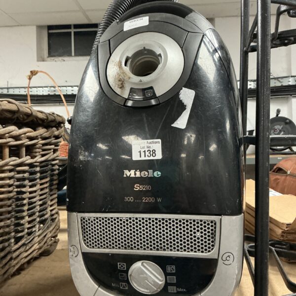 Black Miele S5210 hoover, a vintage domestic cleaning appliance.