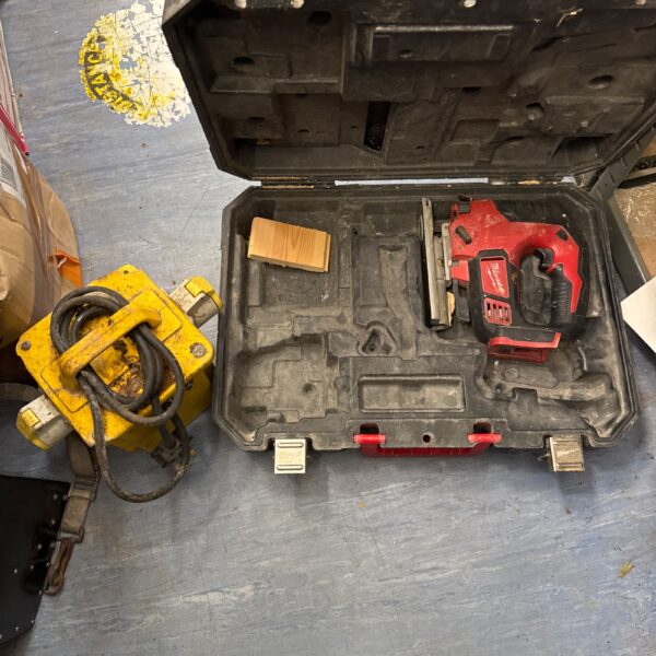 Vintage Milwaukee cordless jigsaw and 110v transformer block.
