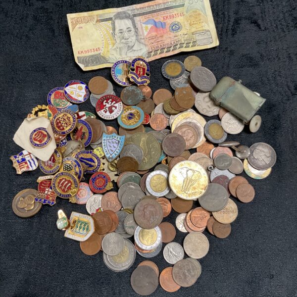 Mixed lot of vintage coins and collectible pin badges.