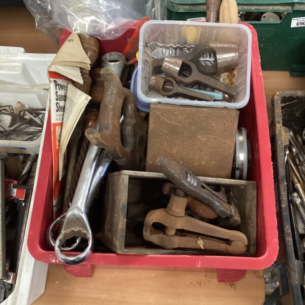 Mixed tool lot with spanners, clamps, and hand drills.