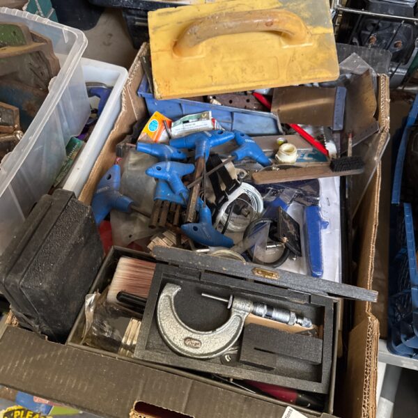 Mixed tool lot in a plastic tray with a micrometer visible.