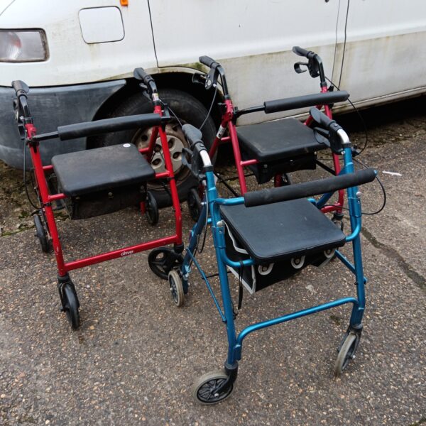Lot of three mobility walkers with adjustable seats and wheels.