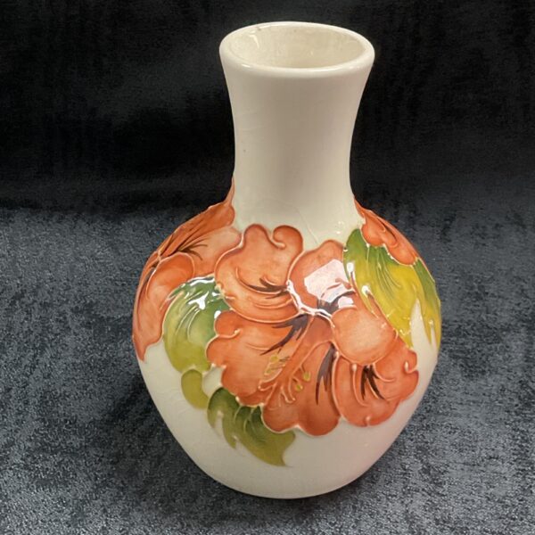 Small Moorcroft vase with vibrant floral design.