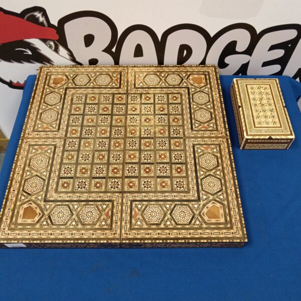 Intricate Moroccan marquetry chessboard and pieces box on display.