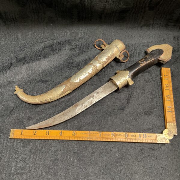 Antique Mortocan jambiya dagger with silver and brass decoration.