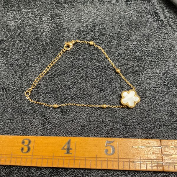 Delicate 18ct gold plated mother of pearl daisy bracelet.