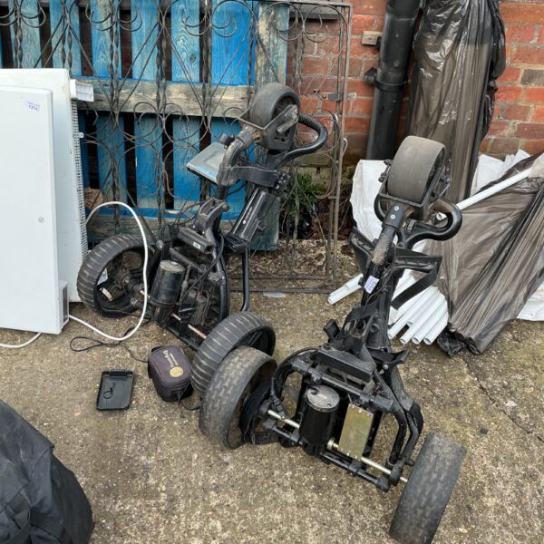 Used Motocaddy electric golf trolley in outdoor setting.