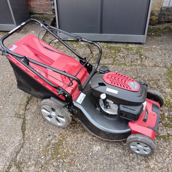 Red Mountfield GCV 170 petrol lawnmower for garden maintenance.