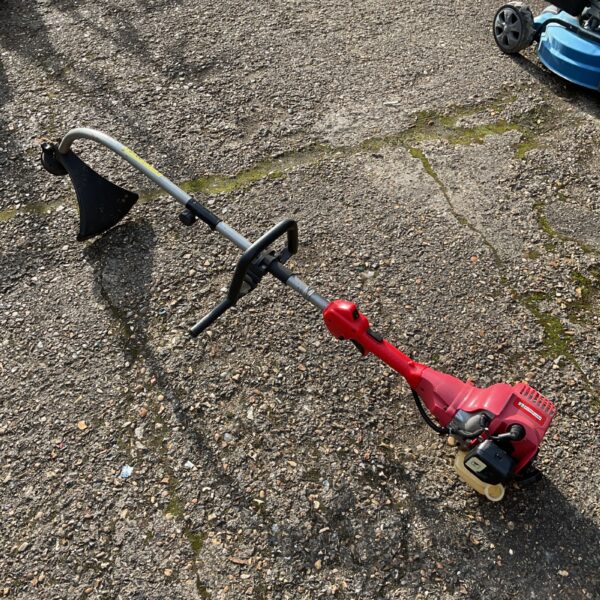 Used Mowerland petrol strimmer for garden maintenance and landscaping.