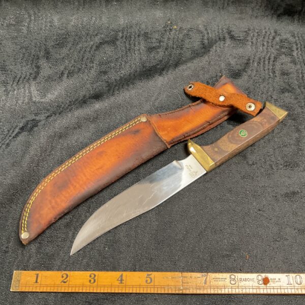 Vintage Muela hunting knife with leather sheath, ideal for outdoor use.