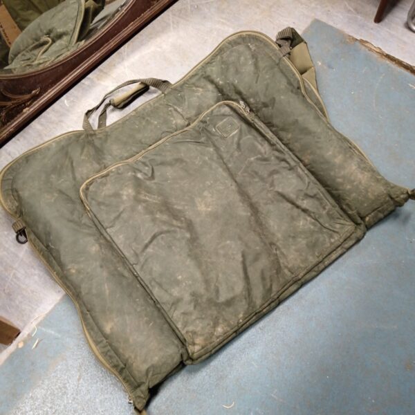 Front view of a used Nash carp unhooking mat for angling.