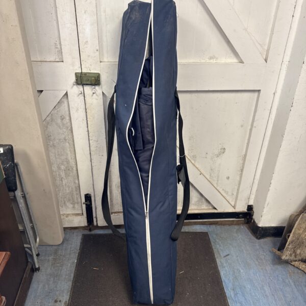 Navy blue folding gazebo case with carrying handles.