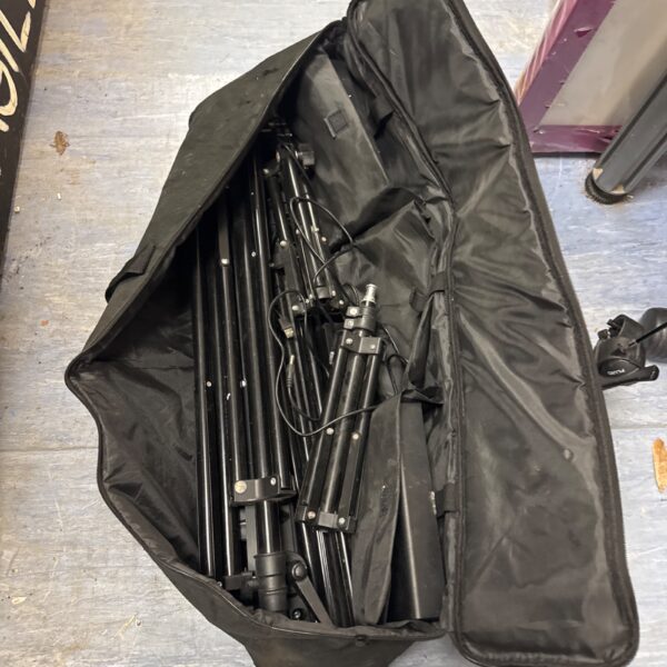 Neewer photography light stand inside a black carry bag.