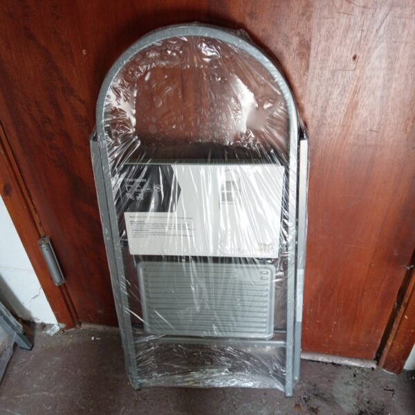 New metal two-step stool still in plastic packaging.