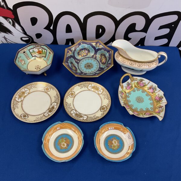 Vintage Noritake china collection featuring floral plates and gravy boat.