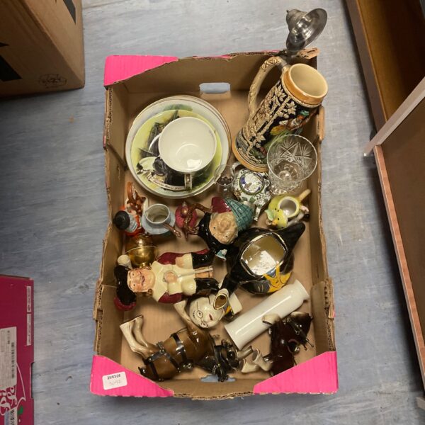 Assorted vintage novelty jugs and china in a cardboard box.
