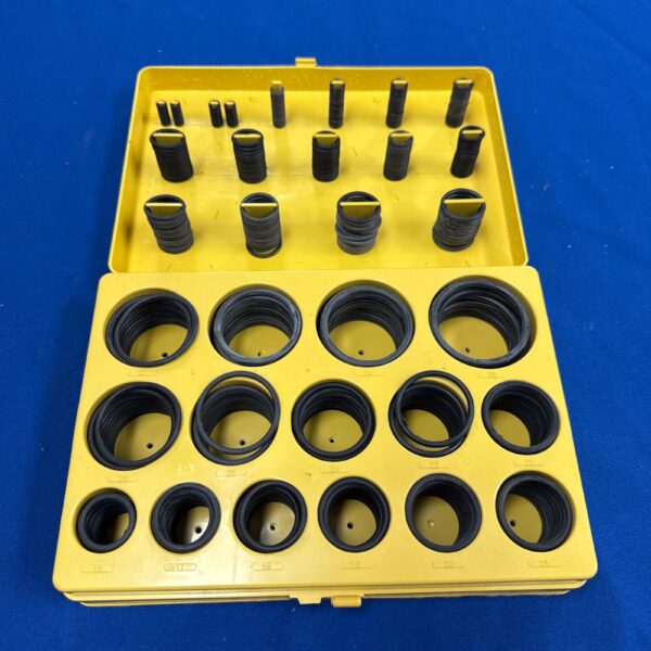 Yellow plastic case filled with assorted black O rings and seals.