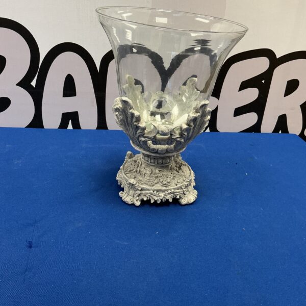 Ornate silver candle holder with clear glass shade for home decor.