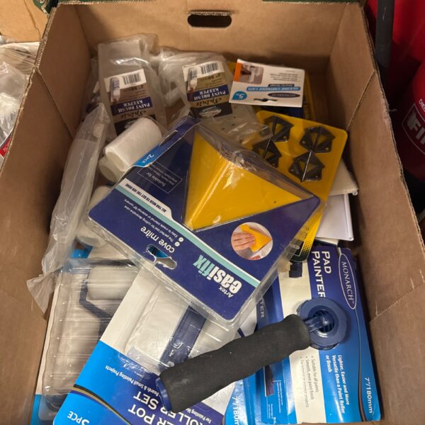Assorted new painting and decorating supplies in original packaging.
