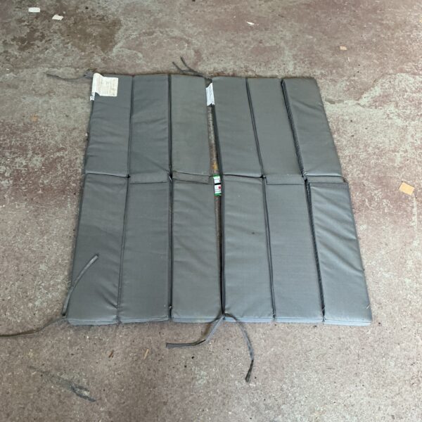 Two neutral-coloured patio bench cushions for outdoor seating.