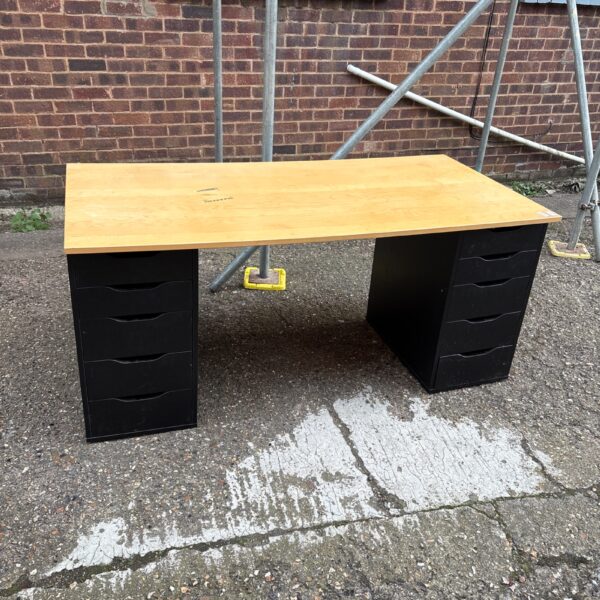 Black pedestal desk with wood-effect worktop for office use.