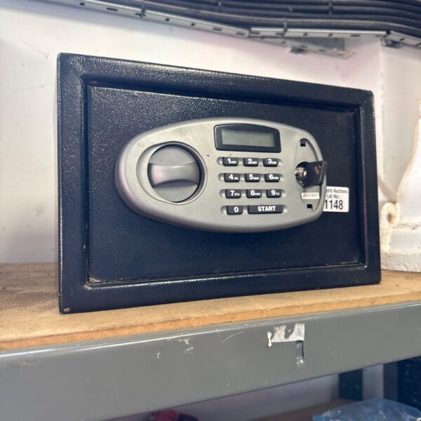 Small personal safe with key lock for securing valuables.