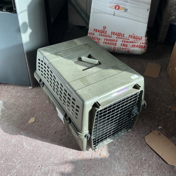 Damaged plastic pet carrier for cats and dogs.