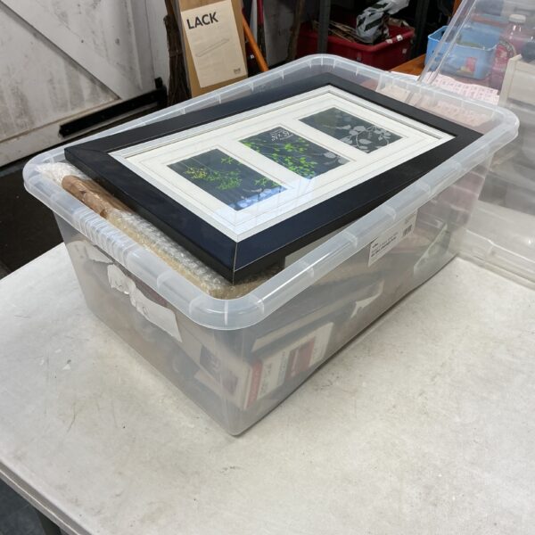 Clear plastic container filled with assorted photo frames.