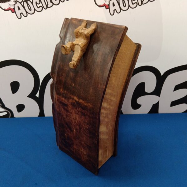 Pierre Decorse book sculpture in olive wood with figure detail.