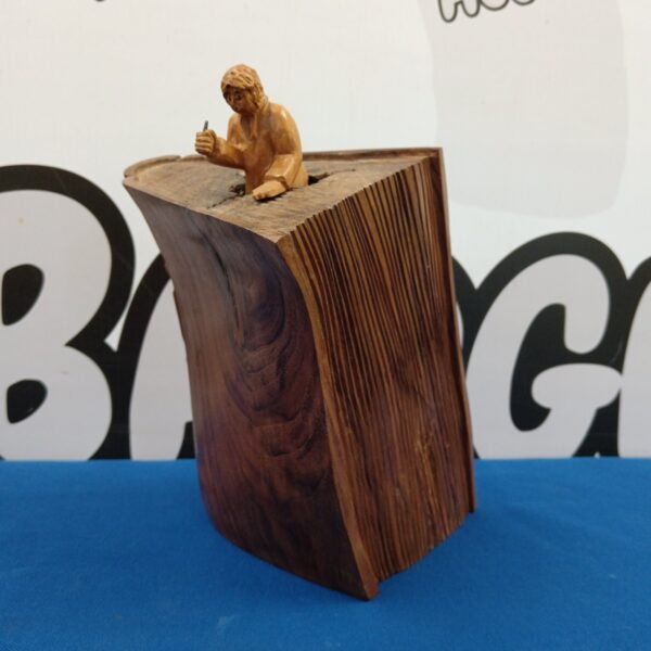 Pierre Decorse wood sculpture featuring a figure on an open book.