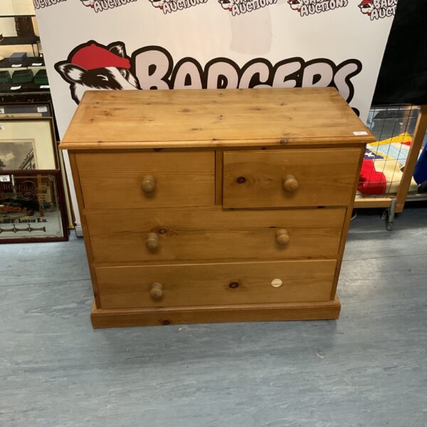 Vintage pine chest of drawers with multiple drawers.