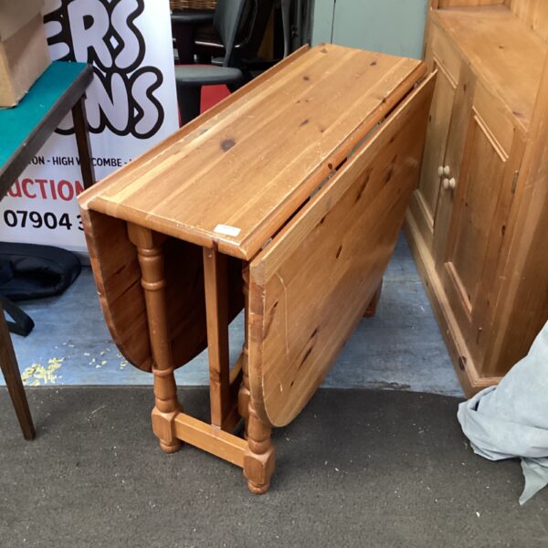 Vintage pine dropleaf table with turned legs.