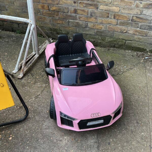 Pink child’s Audi electric ride-on car for sale.