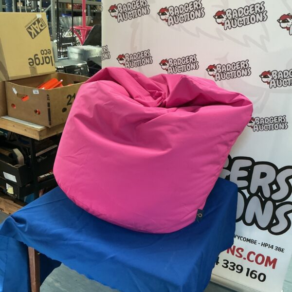 Pink bean bag chair in used condition, providing casual seating.