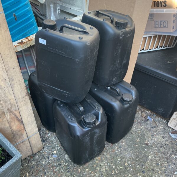 Lot of six dark-coloured plastic containers for storage.