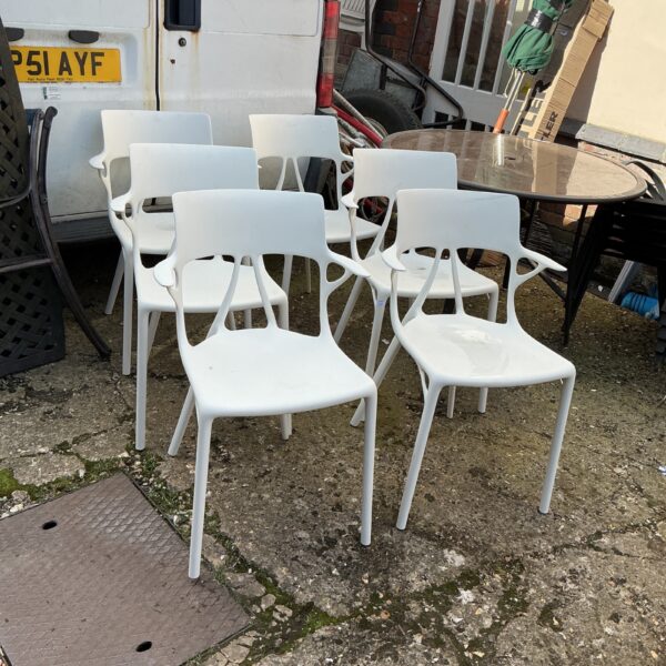 Lot of six plastic garden chairs for outdoor use.
