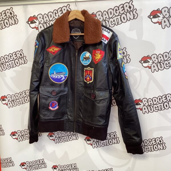 Front view of a vintage Platinum Leathers pilot jacket with patches.