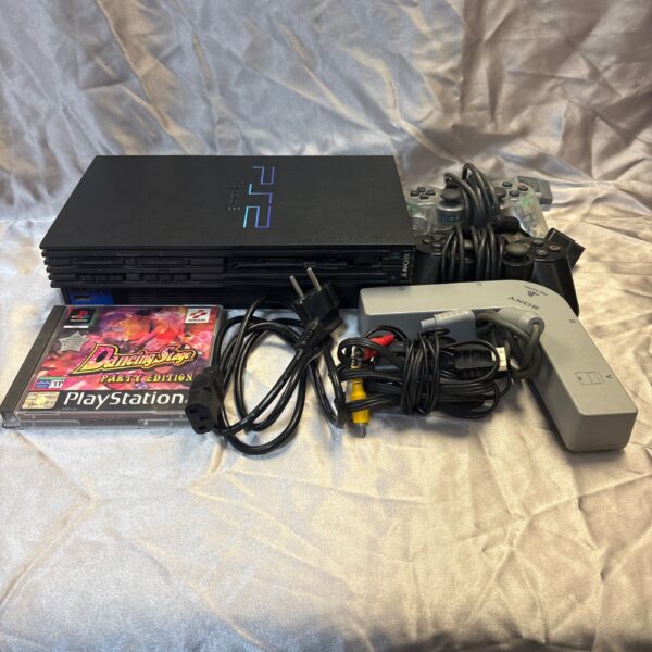 Sony PlayStation 2 console with controllers and game.
